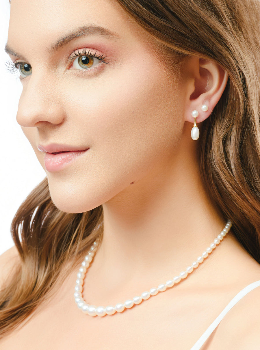 Model wearing pearl drop earrings for bridesmaid styling